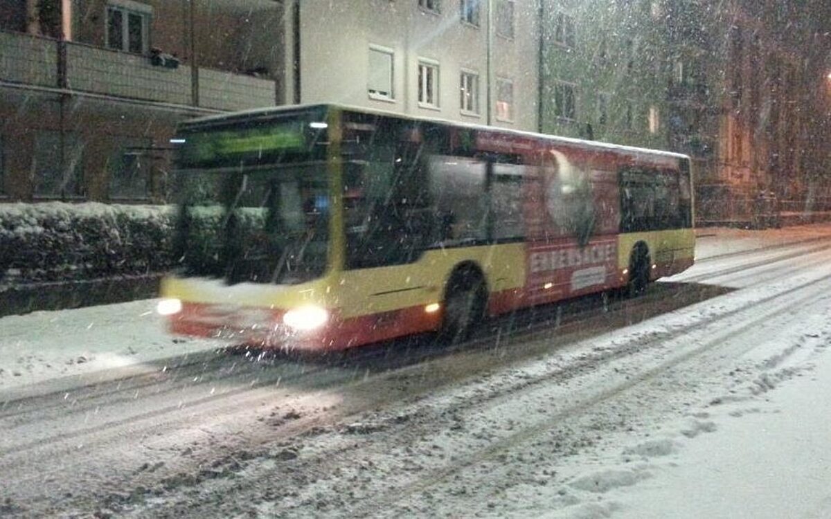 Ein Würzburger Stadtbus fährt über eine verschneite Straße Ein Würzburger Stadtbus fährt über eine verschneite Straße