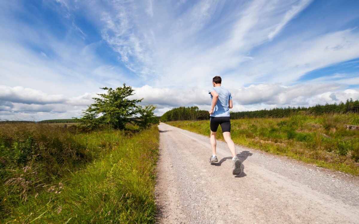 Ein Jogger läuft über Felder Ein Jogger läuft über Felder